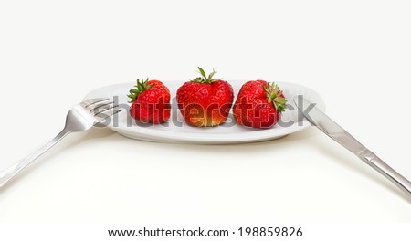 fresh strawberry on plate with knif and fork, isolated on white
