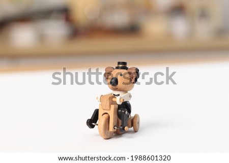 cute bear toy riding a bycicle with white backgropund