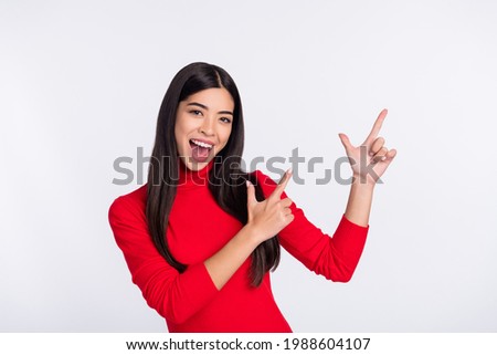 Photo of happy excited cheerful young asian woman point fingers copyspace advertisement isolated on grey color background