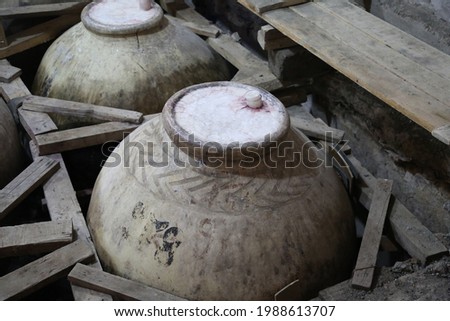 View of old ceramics wine jars called kvevri at the wine factory. Royalty-Free Stock Photo #1988613707