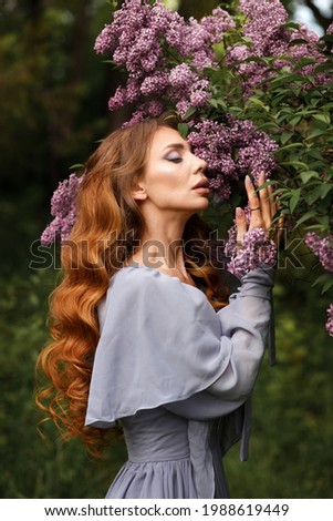 girl with makeup and hairstyle at lilac close-up