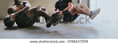 Sportive men working out with fitness balls Royalty-Free Stock Photo #1988637098