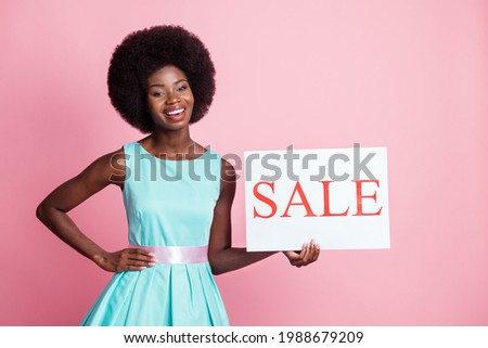 Photo portrait of curly girl demonstrating sale banner on black friday shopping isolated on pastel pink color background