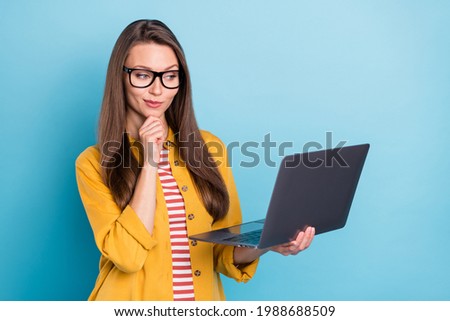 Photo of young business woman happy positive smile work laptop think project programmer isolated over blue color background
