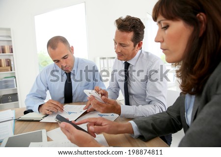Business people checking on smartphone to book meeting time