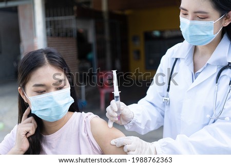 The doctor is using a syringe to give the patient a syringe.