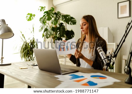 Young businesswoman presenting charts and graphs on video call online. Businesswoman having conference call with client on laptop. Closeup business woman working laptop computer indoor.