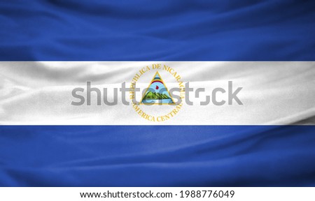 Realistic flag of Nicaragua on the wavy surface of fabric