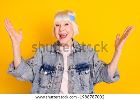Photo portrait of cool positive granny smiling amazed wearing headband isolated on vivid yellow color background