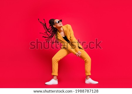 Full body photo of sweet lady dance look empty space wear eyewear yellow suit isolated on vivid red color background