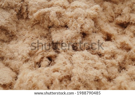 Natural blown wood fiber insulation for heat insulation and insulation of buildings close-up texture Royalty-Free Stock Photo #1988790485