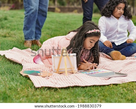 Happy indian family enjoy day at city park - Family, parents and children love - Little indian girl painting with water colors