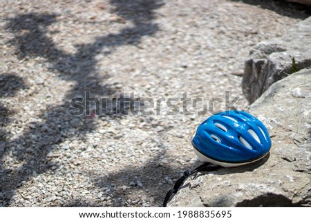 Blue helmet sitting on rock during day in summer