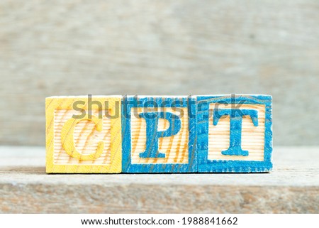 Color alphabet letter block in word CPT (Abbreviation of Carriage Paid To) on wood background