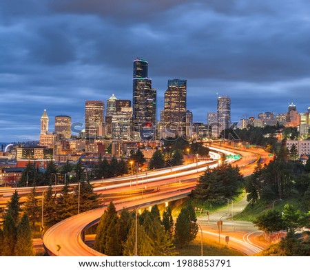 Seattle, Washington, USA downtown city skyline over highways at dusk.