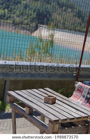 An empty table at a roadside cafe overlooking a reservoir in the Dim Valley, Turkey, April, 2021