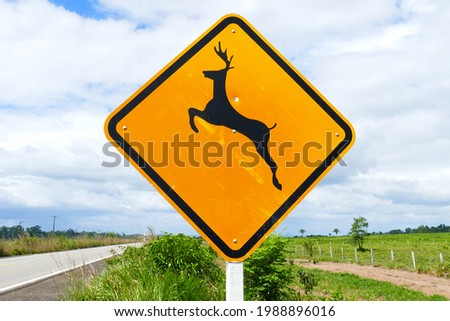 Traffic sign with a jumping deer on the BR174 highway between the cities of Manaus and Boa Vista. The sign serves to protect wildlife and reminds motorists to be careful.