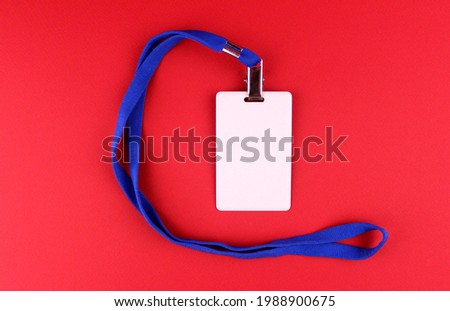 Empty white badge with blue drawstring on red background