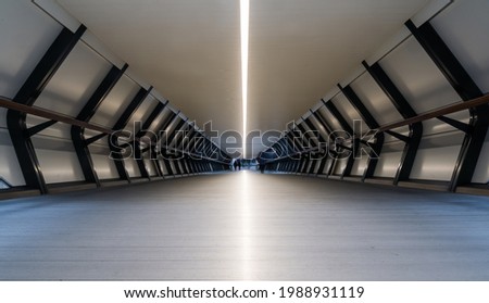 Train station tunnel with geometric symmetry in Canary Wharf Financial center of London, UK Royalty-Free Stock Photo #1988931119