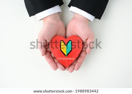 Business man's hands and Heart object with Japanese beginner's sign