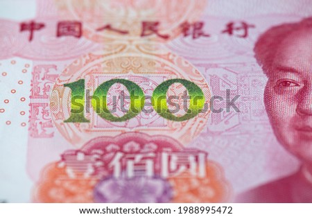 Top view of 100 Chinese Yuan paper currency in shallow depth of field
