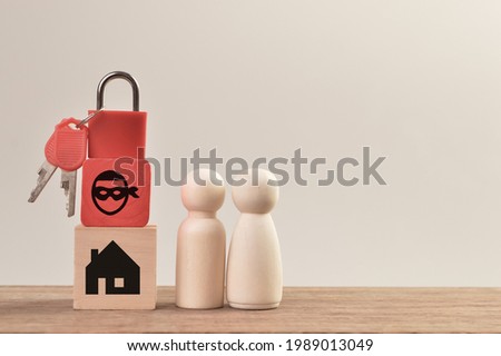 Wooden doll figures with padlock, scammer and home. Real estate scam concept. Royalty-Free Stock Photo #1989013049