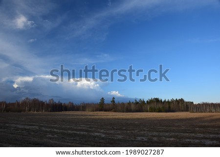 Early spring landscape with beautiful cloudy sky. Stock Photo