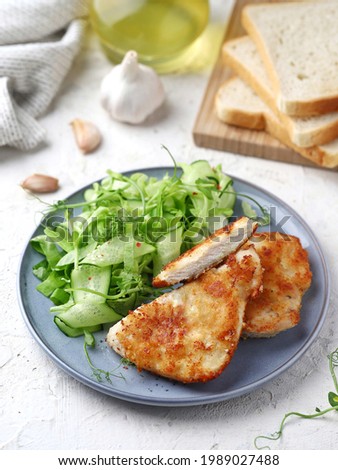 Fresh ruddy potato hash brown with salad and sour cream sauce on a light background