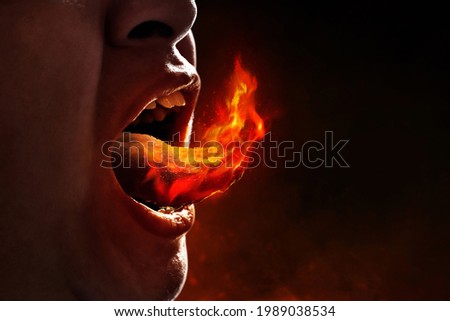 Young man eating spicy food Royalty-Free Stock Photo #1989038534