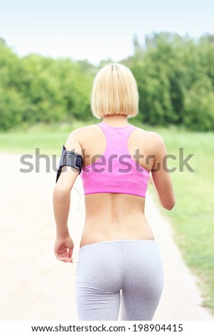 A picture of an active woman jogging in park