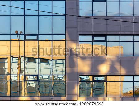 Mirrored windows in the building as a background.