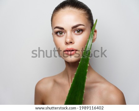 young woman clean skin cosmetology aloe leaf bare shoulders model Copy Space