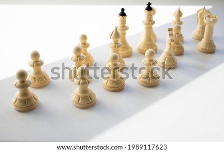chess, white pieces on a light table surface, indoors. Intellectual games for children and adults, logic, thinking, chess on the table