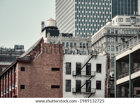 Color toned picture of Manhattan cityscape with water tower and fire escape, New York City, USA.