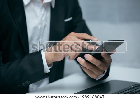  Asian businessman uses a job search Smart phone computer to search for information on his financial business.