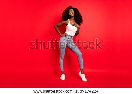 Full size photo of young attractive black girl hands on chest happy positive smile laugh isolated over red color background