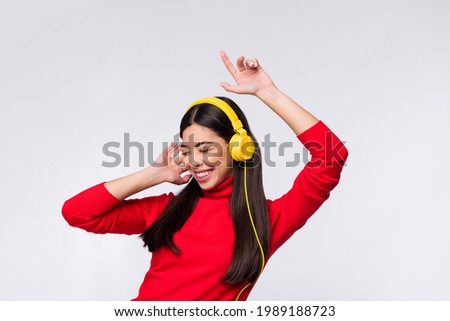 Photo of young happy excited beautiful korean girl dancing listen music in headphones isolated on grey color background
