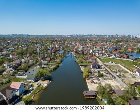 River in a suburban village. Aerial drone view.
