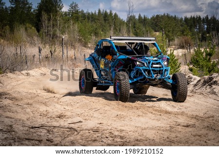 Summer UTV, ATV  offroad driving in dust. Quad racing Royalty-Free Stock Photo #1989210152