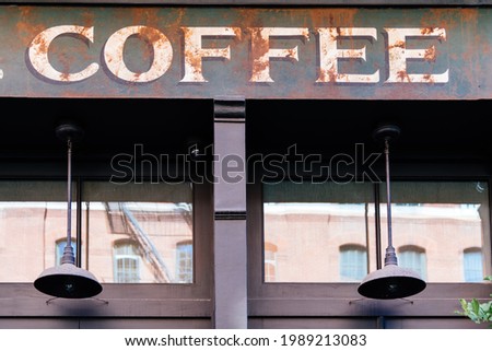 Coffee sign on Top of vintage or retro style store window.