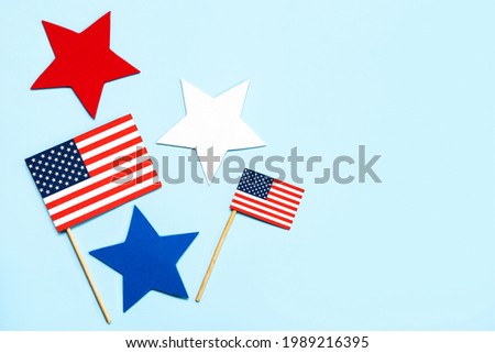 Independence day July 4th. American flags and stars with copy space on a blue background