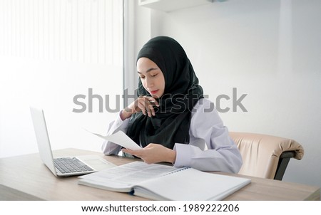 Young muslim student writing and learning  in the room. E-learning online education.