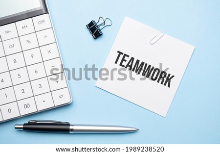 On a blue background, glasses, calculator, coffee, magnifier, pen and notebook with the text teamwork