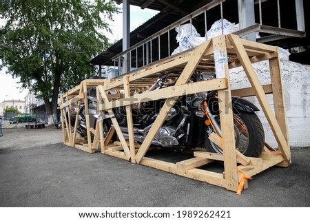 Delivery of a motorcycle imported from another country in wooden crates.