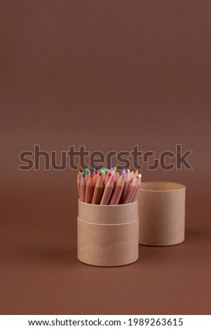 Eco colored pencils made from recycled material. A set of wooden pencils in a box. Top view. Free space for text. High quality photo. 