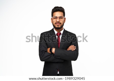 Portrait of young indian businessman with crossed arms on white isolated background. Royalty-Free Stock Photo #1989329045