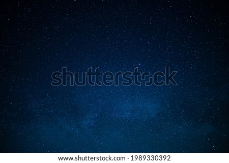 Night starry sky. Small stars are visible in the dark blue sky. A majestic picture. No people. Background. Wallpaper. Texture. Place for your insert. Minimalism.