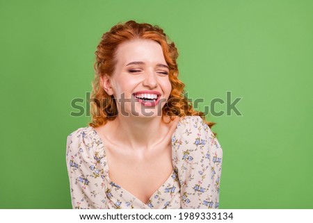 Photo of cheerful young joyful woman smile joke funny good mood face isolated on green color background