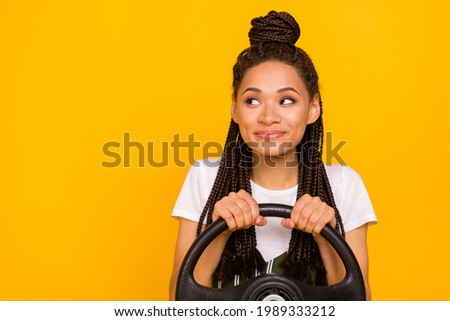 Photo of dreamy happy afro american young woman look empty space drive car isolated on yellow color background