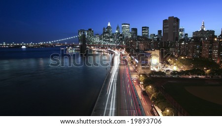 New York City at night- view of FDR highway, city skyline, and Brooklyn Bridge